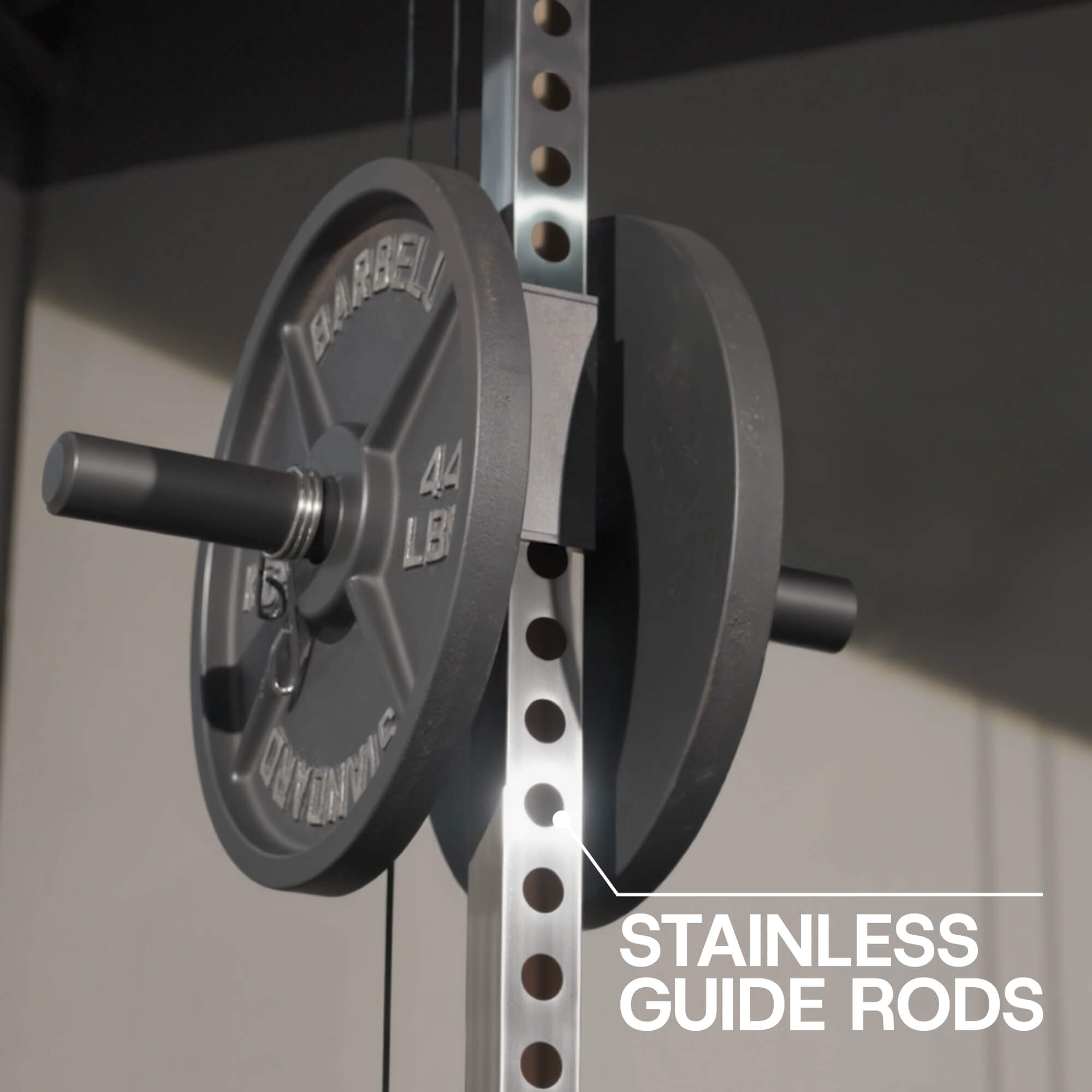 Barbell with weight plates on a rack with 'Stainless Guide Rods' text.