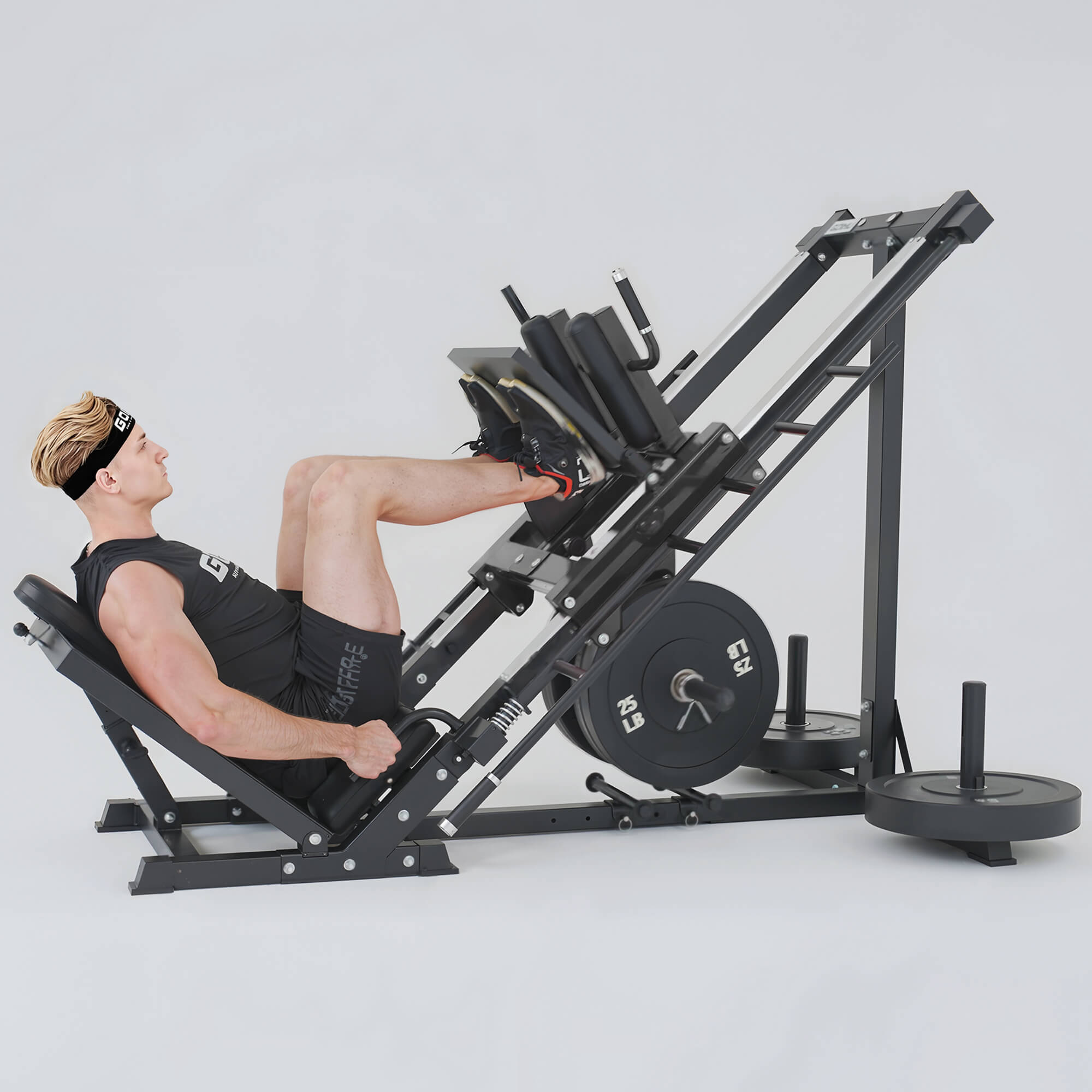 Person using a leg press machine in a gym setting.#color_black