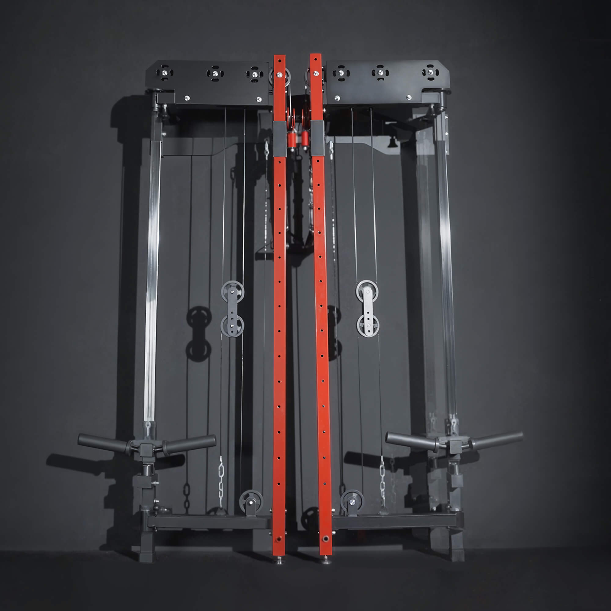 Gym machine with red cables on a dark background.