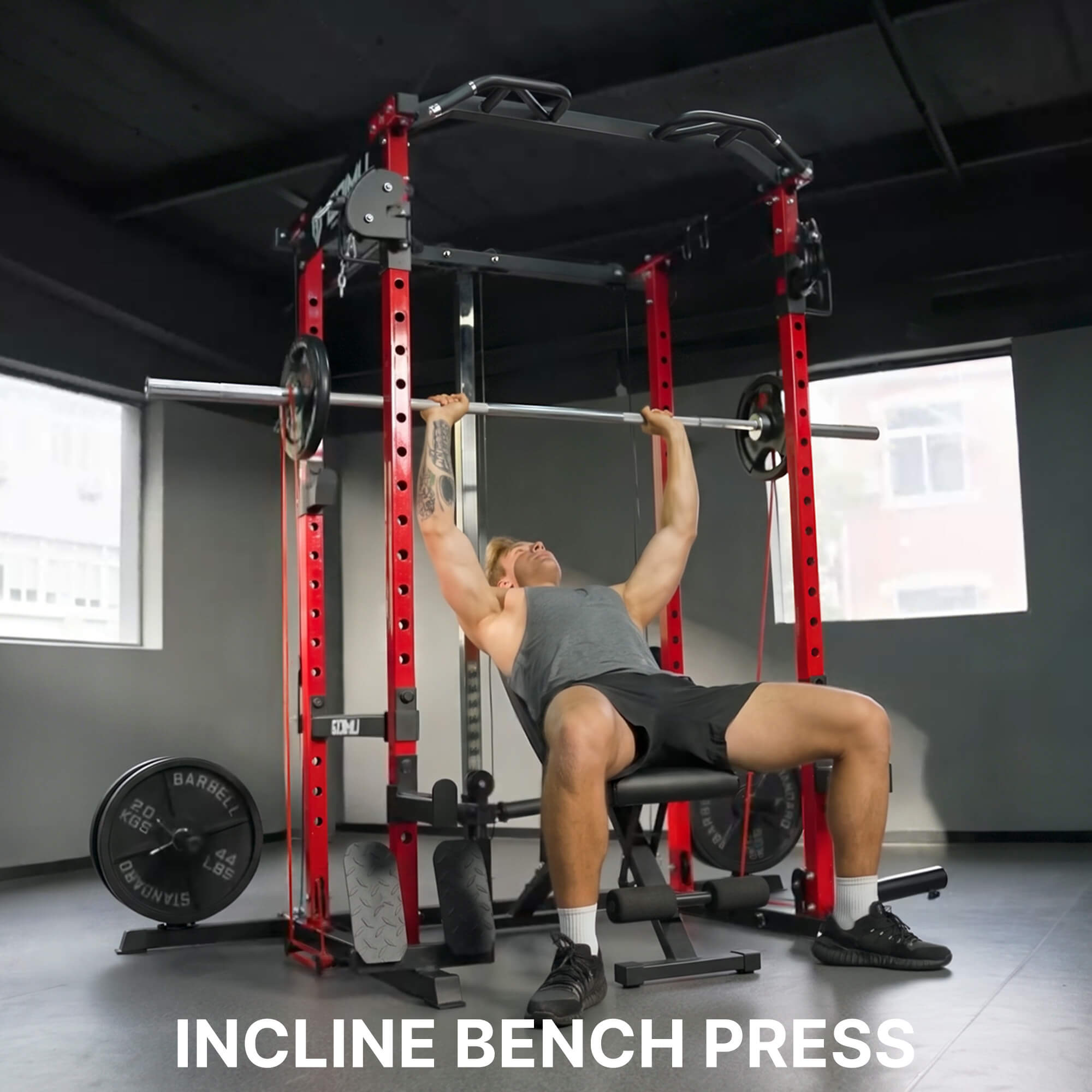 Man performing an incline bench press in a gym setting with 'INCLINE BENCH PRESS' text.