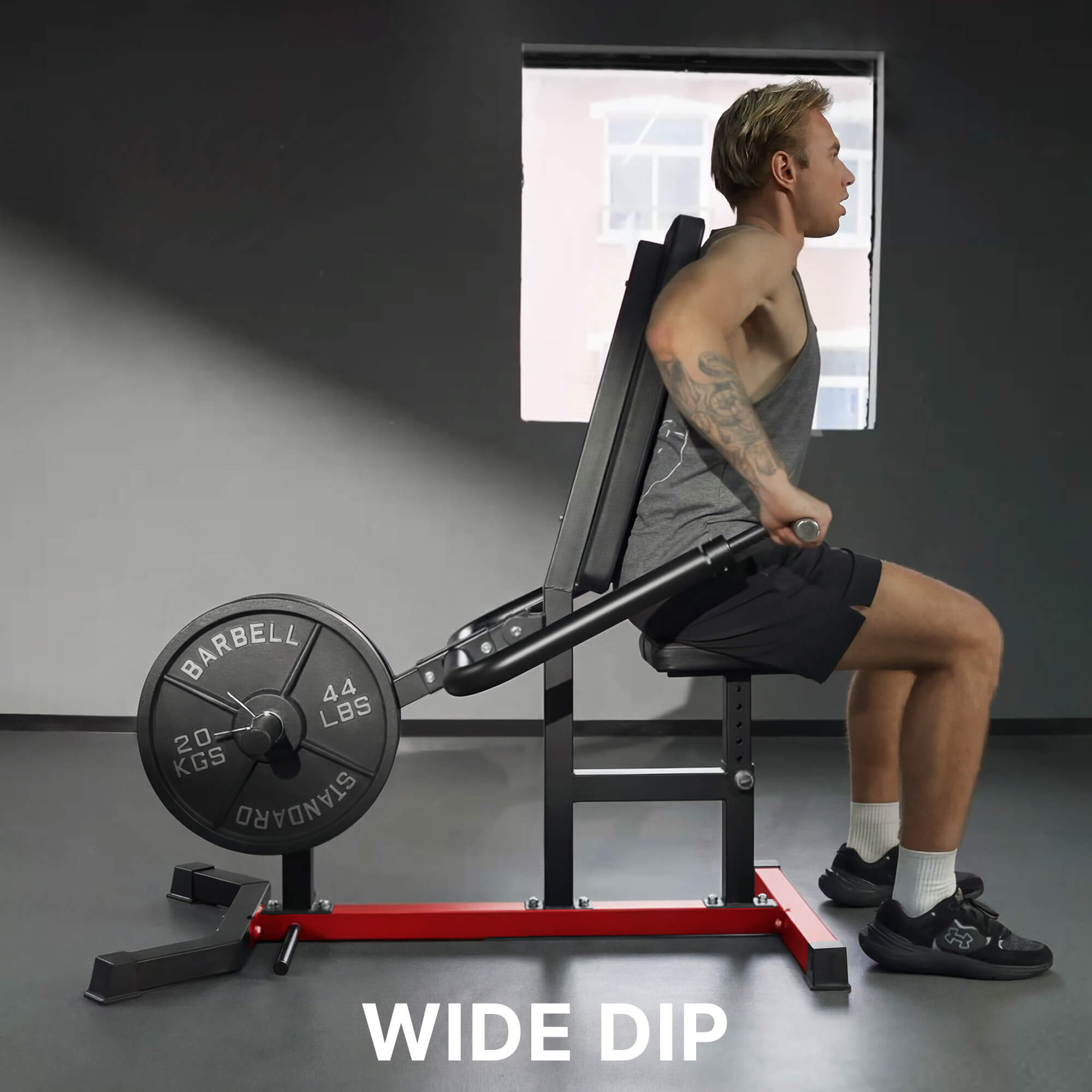 Person using a weight machine labeled 'Wide Dip' in a gym setting.