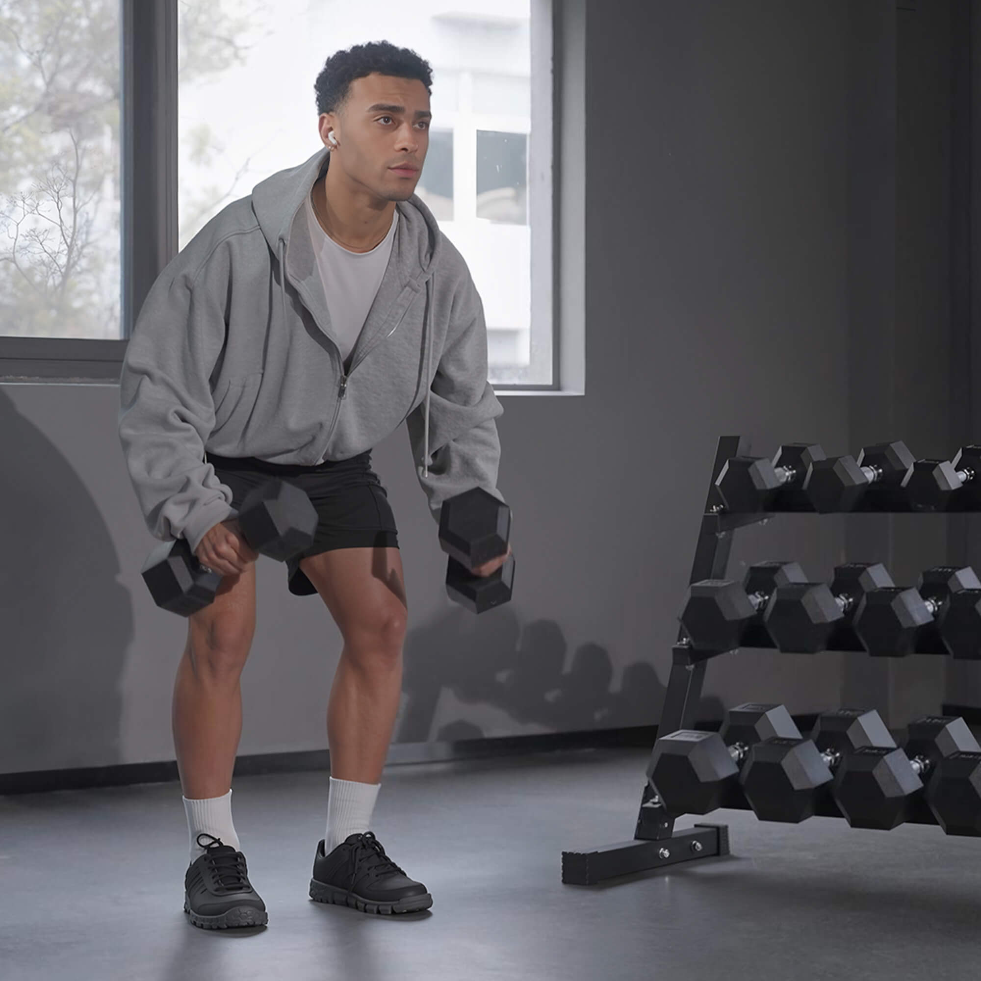 Man exercising with dumbbells in a gym setting.#pounds_160lbs-only-weight