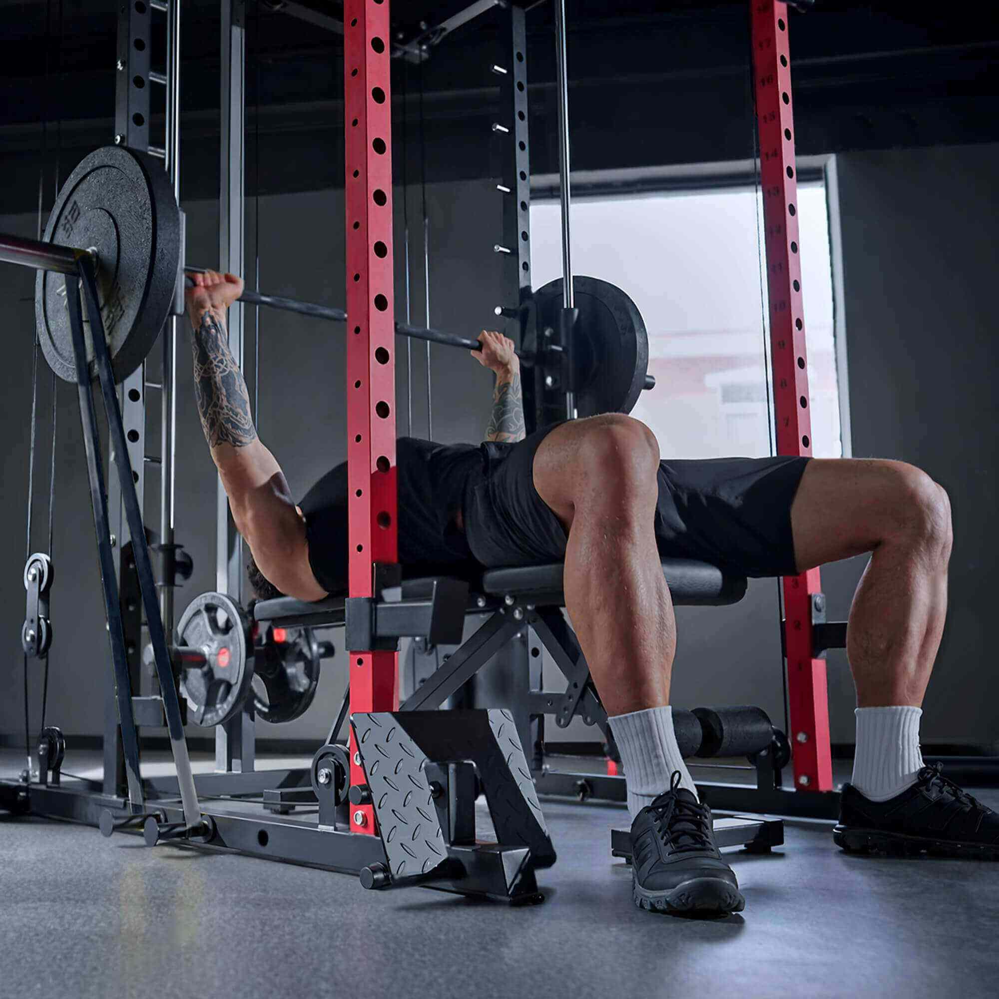 Person performing a bench press in a gym setting.