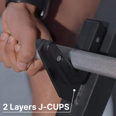 Close-up of hands gripping a barbell with '2 Layers J-CUPS' text.#color_black