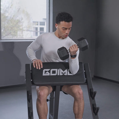 Person using a black weight bench with 'GOIMU' branding while lifting dumbbells indoors.#color_black