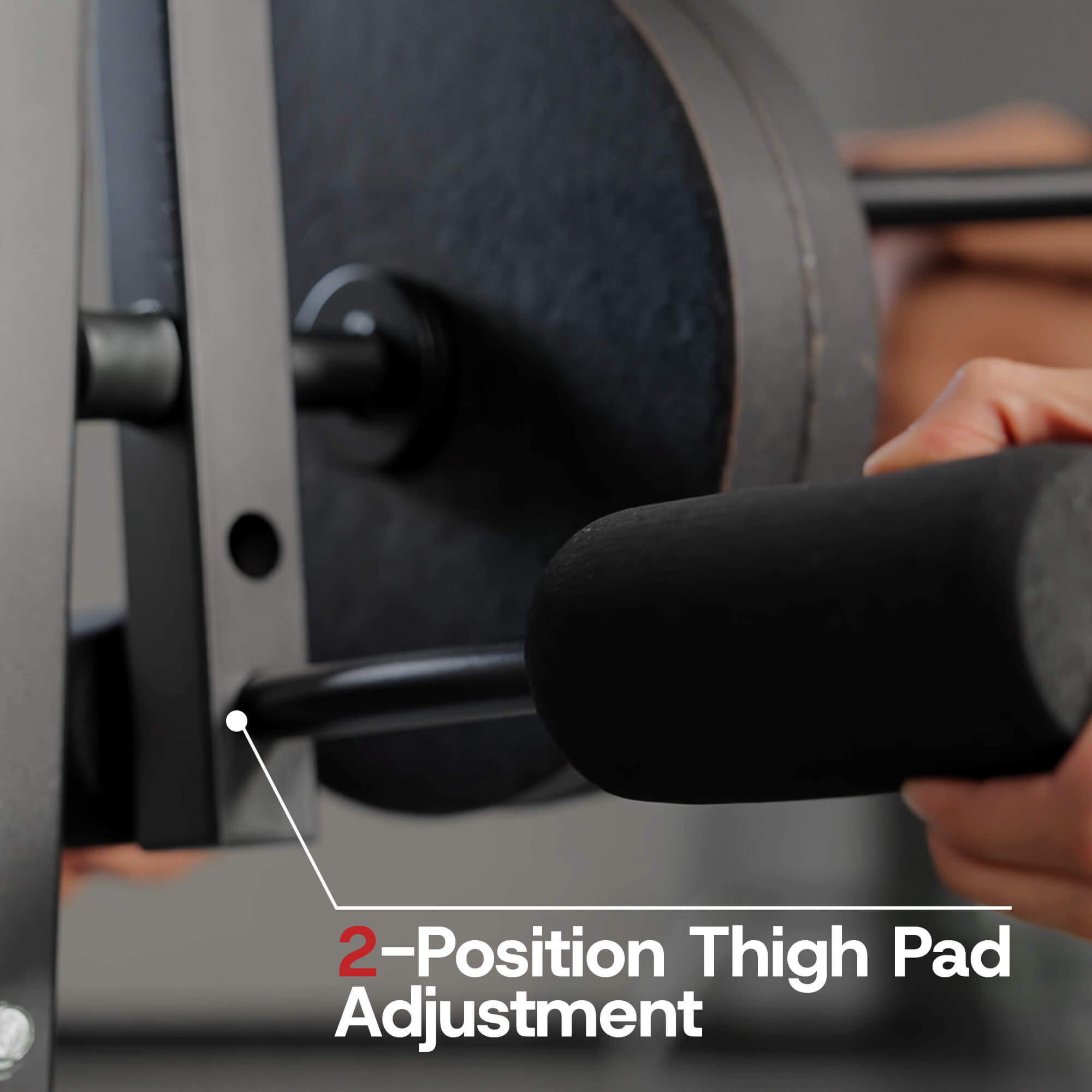 Close-up of a weight bench with a thigh pad adjustment feature, showing a person using the equipment.