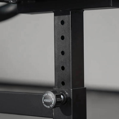 Close-up of a black metal frame with a knob on a gray background.