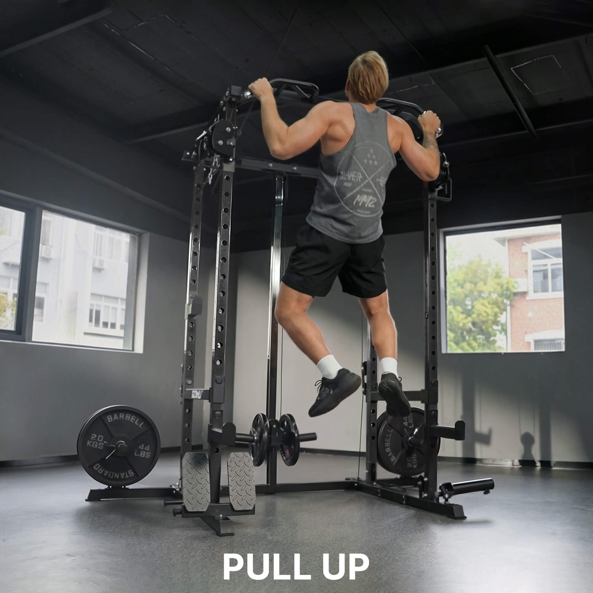Person performing pull-ups on a pull-up bar in a gym setting.
