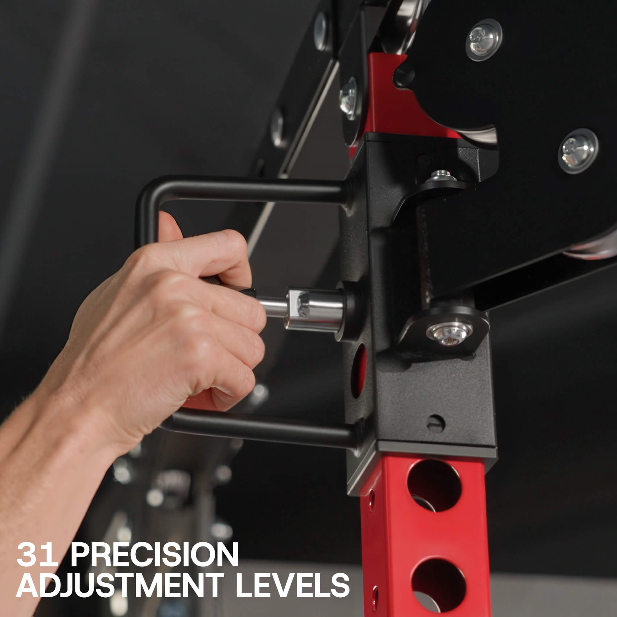 Hand making precise adjustments on a piece of gym equipment with text '31 Precision Adjustment Levels'.