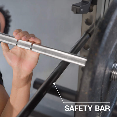 Person holding a safety bar on a weightlifting machine.