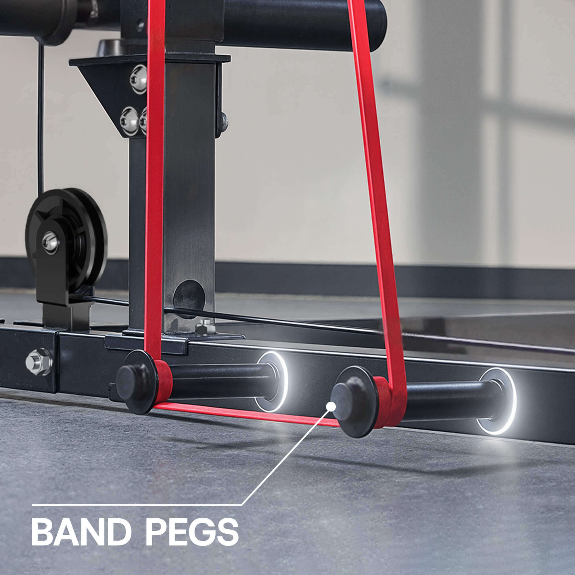 Close-up of a piece of exercise equipment with red bands and band pegs labeled.