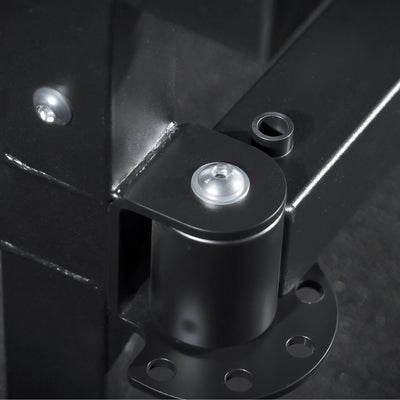 Close-up of a black metal bracket with screws on a dark background.
