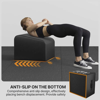 Person using a black exercise bench with anti-slip bottom on a gray floor.