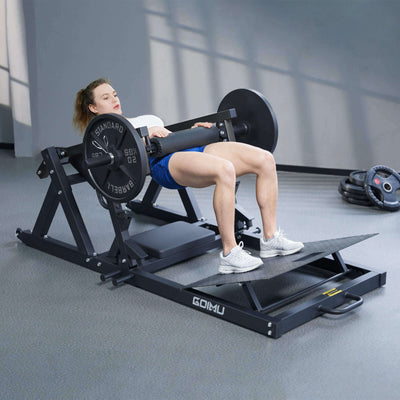 Woman exercising on a leg press machine in a gym setting.