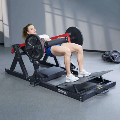 Woman using a leg press machine in a gym setting.