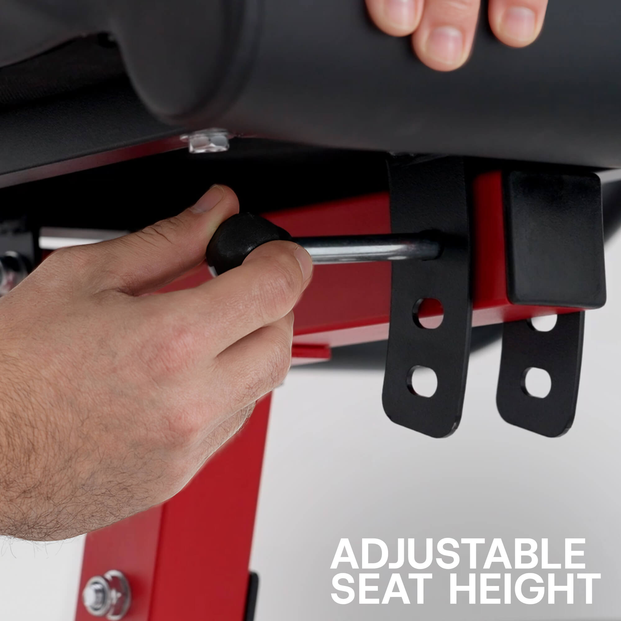 Person adjusting an adjustable seat height mechanism on a piece of equipment.