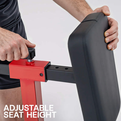 Person adjusting an adjustable seat height on a piece of exercise equipment with a white background.