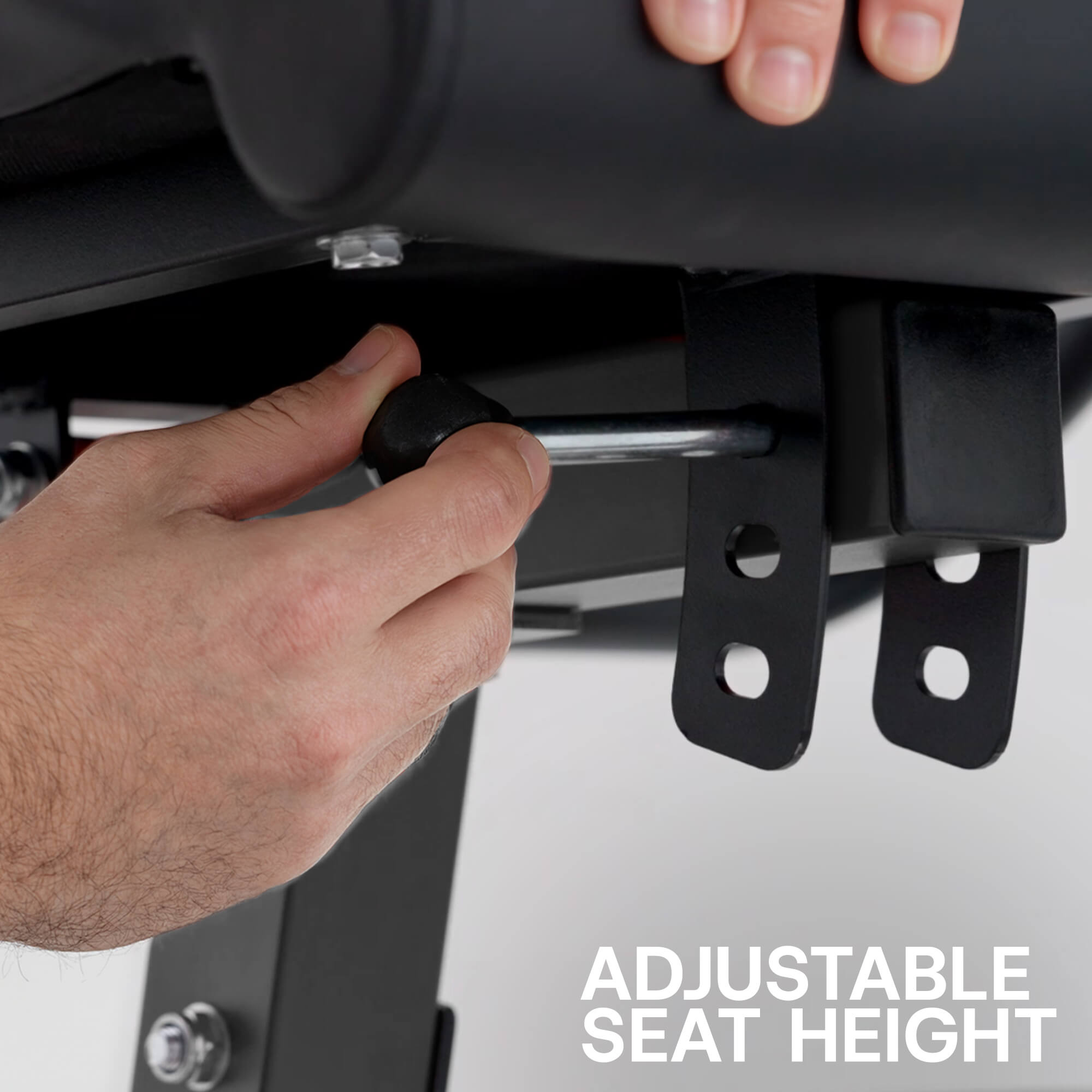 Person adjusting an adjustable seat height mechanism on a vehicle.