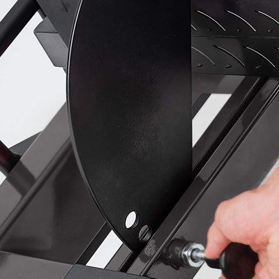 Person using a screwdriver to tighten a screw on a black metal object.#color_black