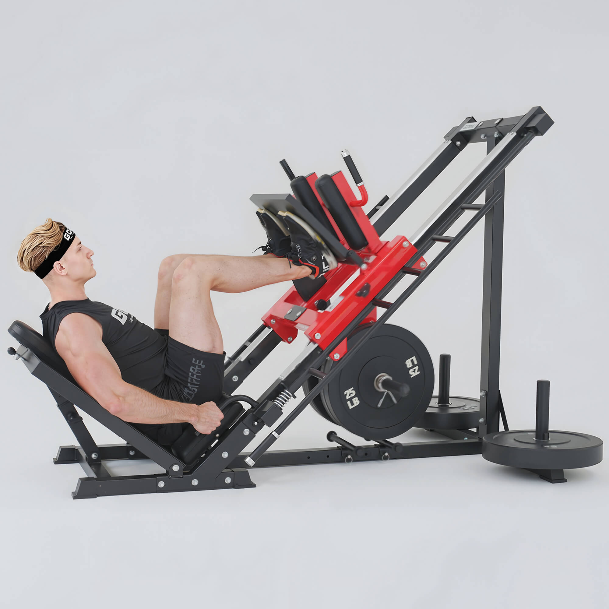 Person using a leg press machine in a gym setting.#color_red