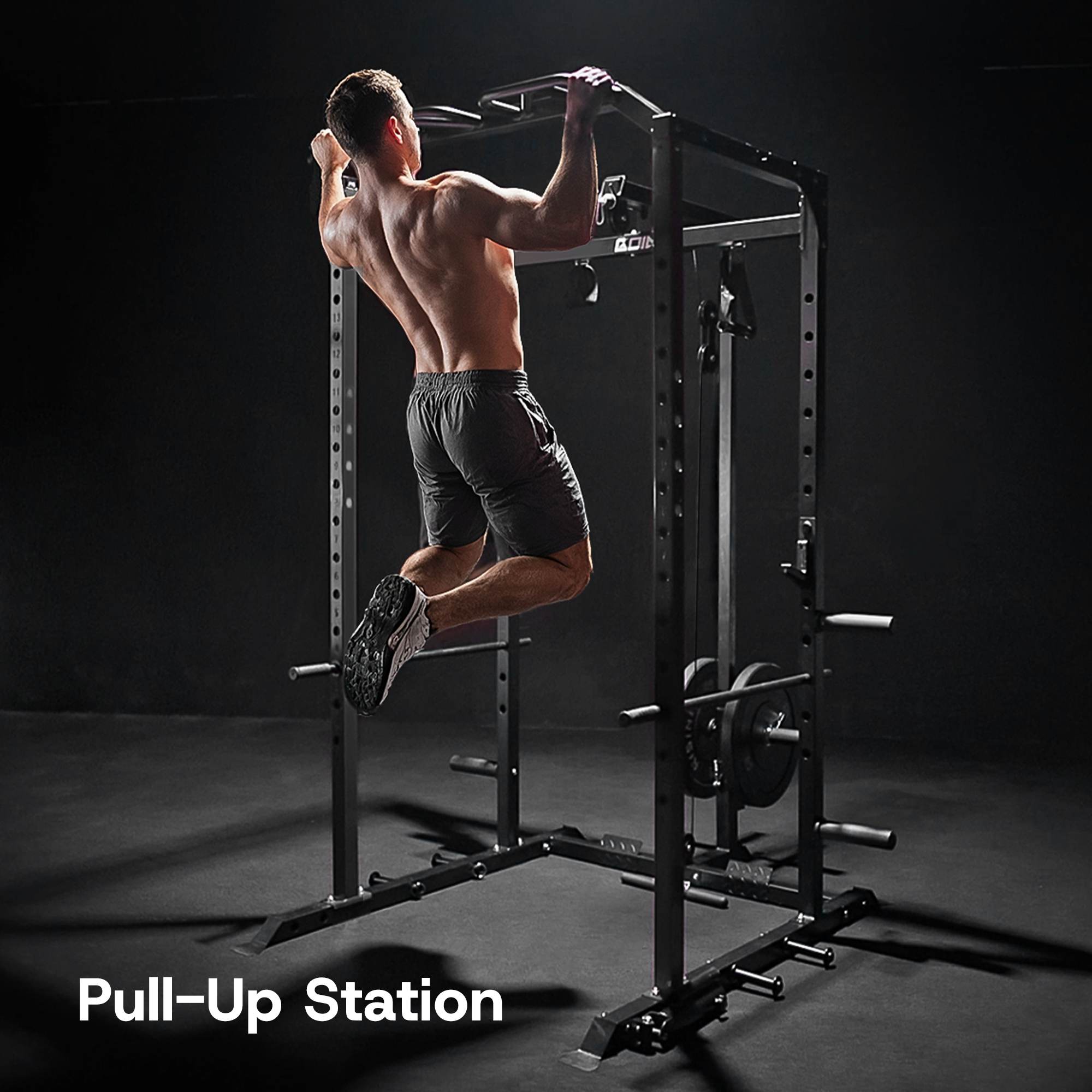 Man performing pull-ups on a pull-up station with a dark background.#color_black