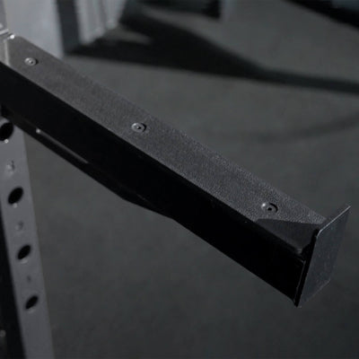 Black metal shelf bracket on a dark background.