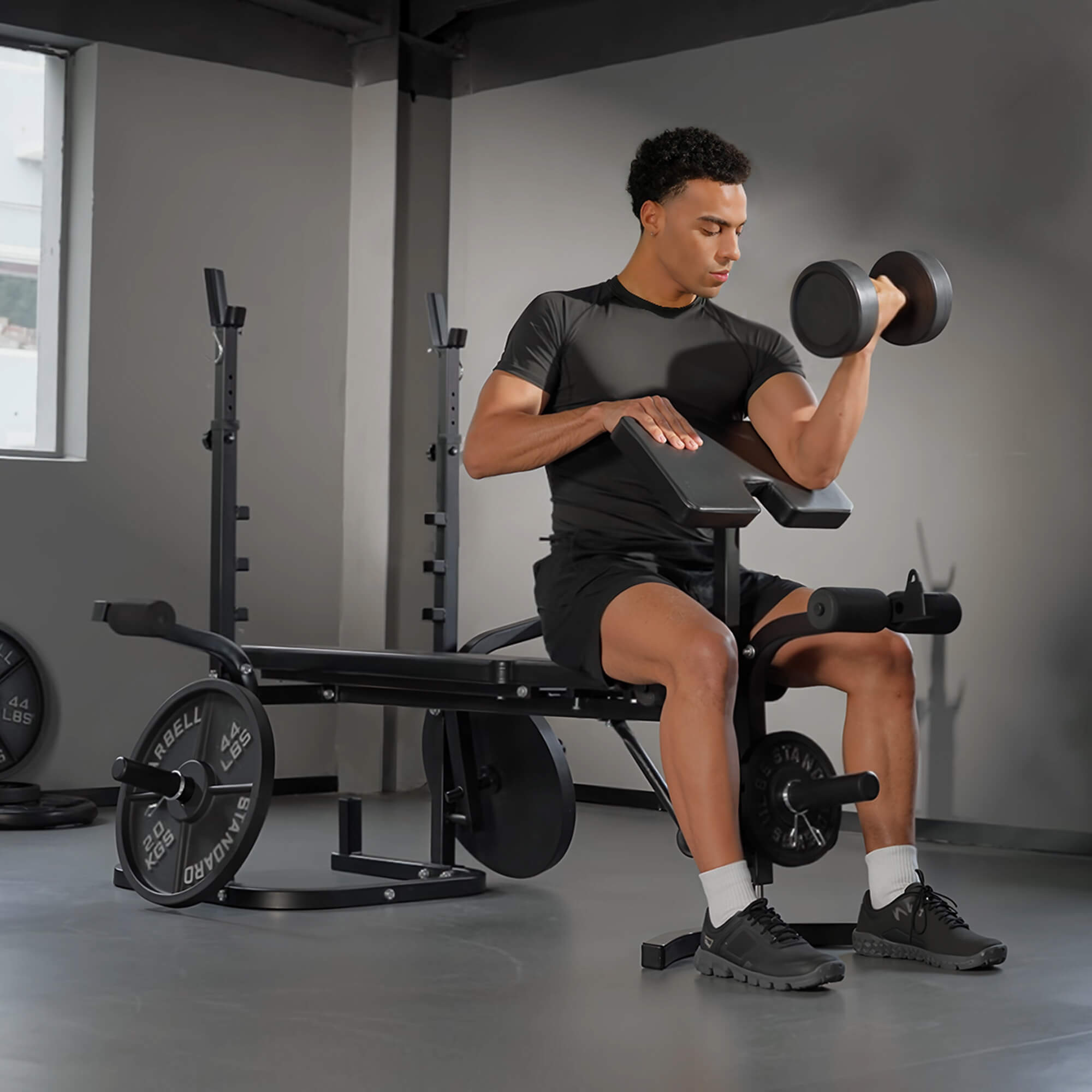 Man exercising with dumbbells in a gym setting