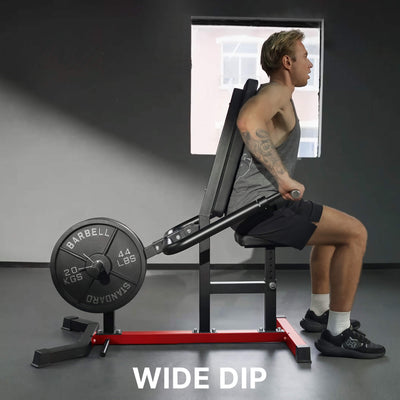 Person using a weight machine labeled 'Wide Dip' in a gym setting.
