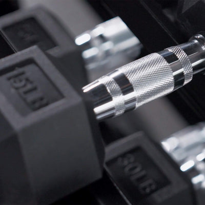 Close-up of a dumbbell with a focus on the weight handle.#pounds_550lbs-with-rack