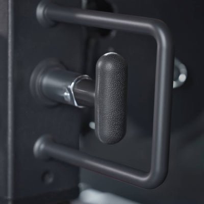 Close-up of a metallic handle on a black surface.