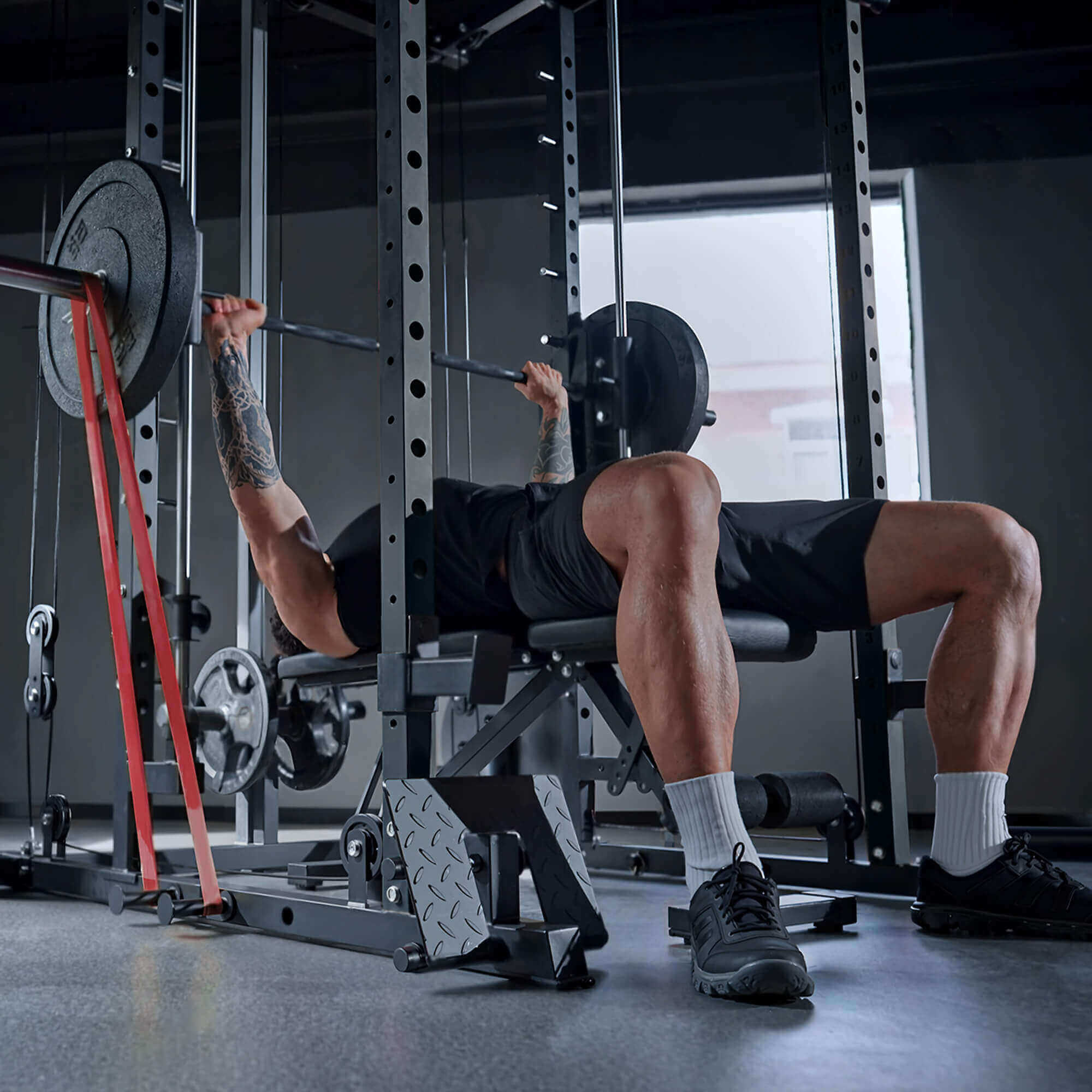 Person performing a bench press in a gym setting.