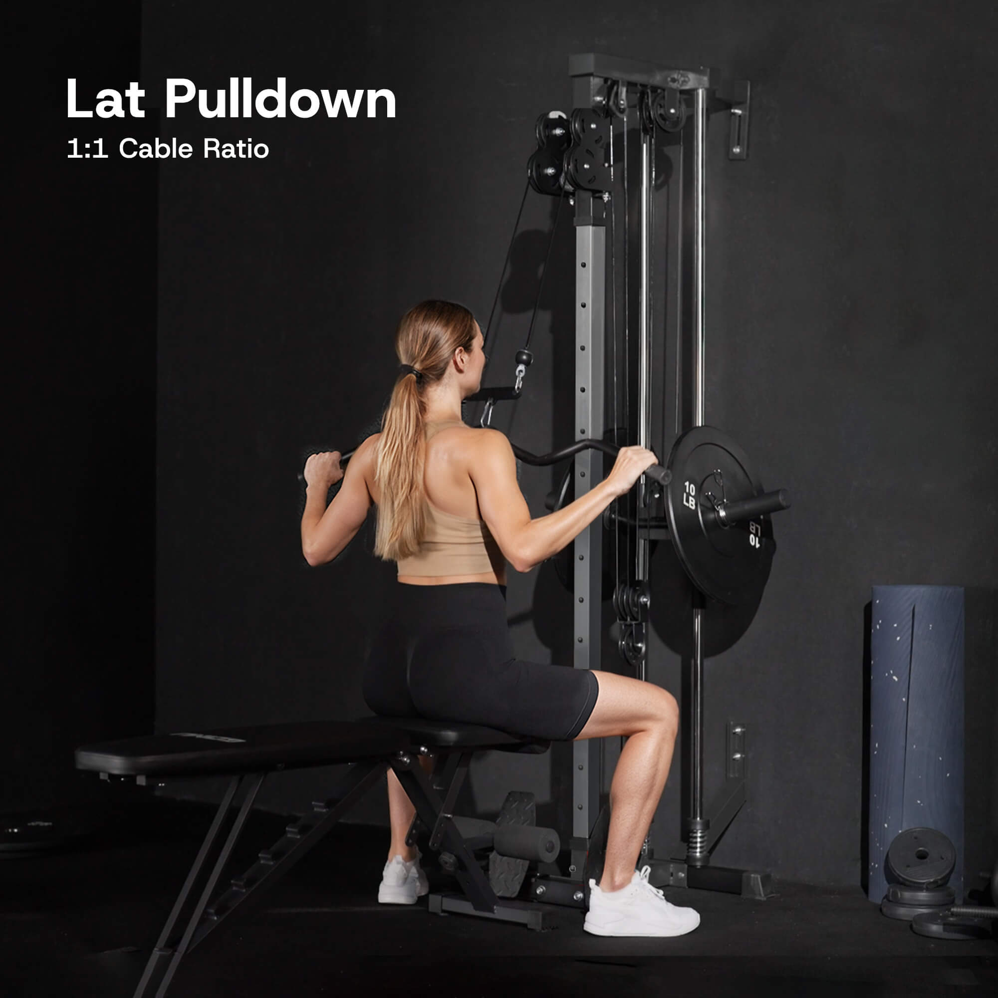 Woman using a lat pulldown machine with text 'Lat Pulldown 1:1 Cable Ratio' on a dark background.